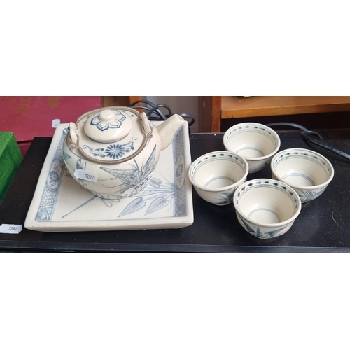 821 - A lovely set of four Chinese tea bowls, teapot and serving tray all decorated in delicate blue and w... 