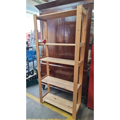 885 - A tall wooden shelving unit with five shelves. H177cm x W83cm x D30cm.