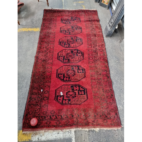 888 - Star Lot - A very fine hand knotted Persian style woolen rug with short tassel trim in shades of dee... 