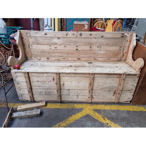 859 - A charming large 19th century pine bench with carved curvilinear arms and slatted back. this item ha... 