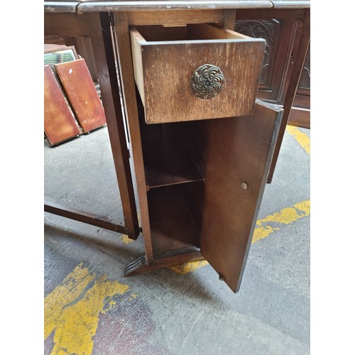 881 - A handsome vintage drop leaf gate leg table with storage compartments in the form of a single drawer... 