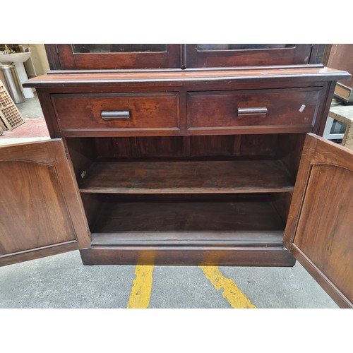 882 - Star Lot : A very large and impressive wooden dresser with glass fronted display cabinet to top hold... 