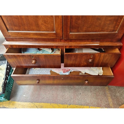 883 - Star lot : A very large Victorian mahogany wardrobe with a large clothes hanging compartment to top ... 