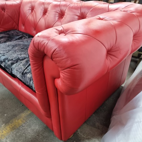 721 - Star Lot : A striking Chesterfield style sofa upholstered in a red button back leather with a trio o... 