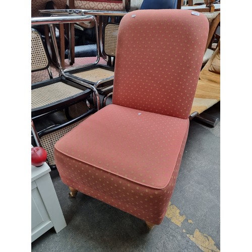 852 - A charming nursing chair with wide comfortable seat upholstered in a terracotta star pattern fabric.... 