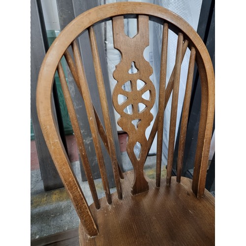 887 - A delightful vintage pair of wheelback chairs with lovely carved and turned wood detailing throughou... 