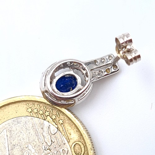 10 - Star Lot : A stunning pair of 9 carat White gold Blue Sapphire stud earrings, featuring beautiful de... 