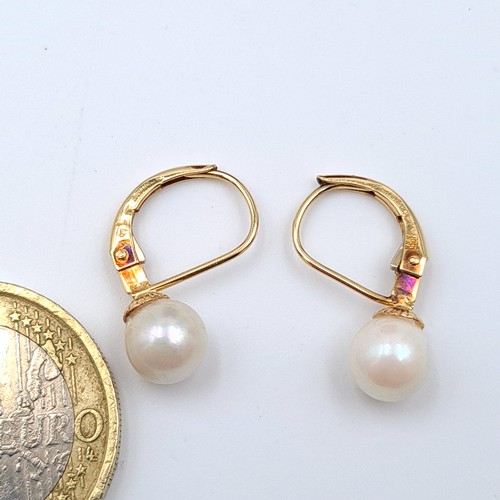 20 - A beautiful pair of vintage 14 carat gold pearl earrings, set with arched backs. Weight: 1.57 grams.