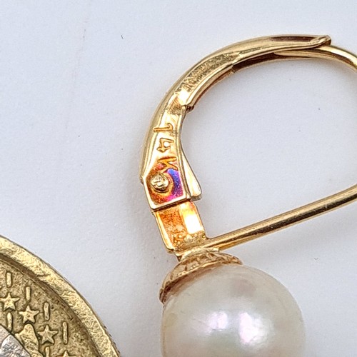 20 - A beautiful pair of vintage 14 carat gold pearl earrings, set with arched backs. Weight: 1.57 grams.