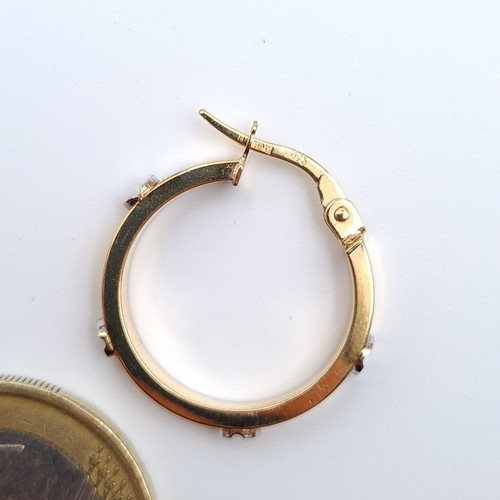 23 - A clean pair of 9 carat gold Italian hooped earrings, stamped 375 Italy. Set nicely with raised acce... 