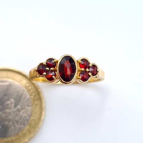 24 - A fabulous vintage three stone Garnet 9 carat gold ring, featuring striking deeply hued Garnets and ... 