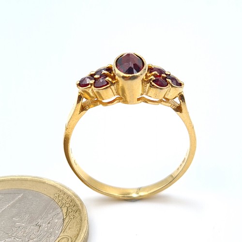 24 - A fabulous vintage three stone Garnet 9 carat gold ring, featuring striking deeply hued Garnets and ... 