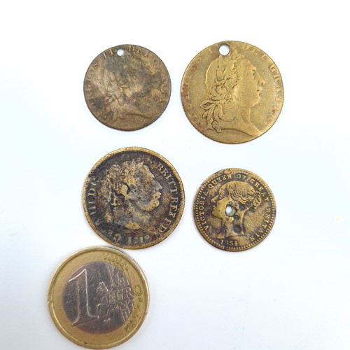 59 - A collection of four coins, consisting of two spade guinnie gambling tokens, a Queen Victoria double... 