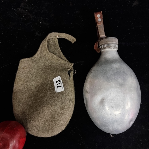 713 - A World War II German metal water bottle with a fleece carrier and leather trap.