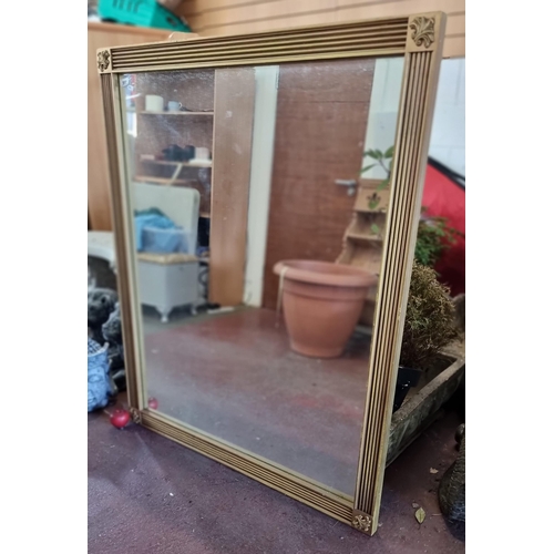 900 - A a very large giltwood wall mirror. With reeded frame and some subtle foliate cresting to corners. ... 