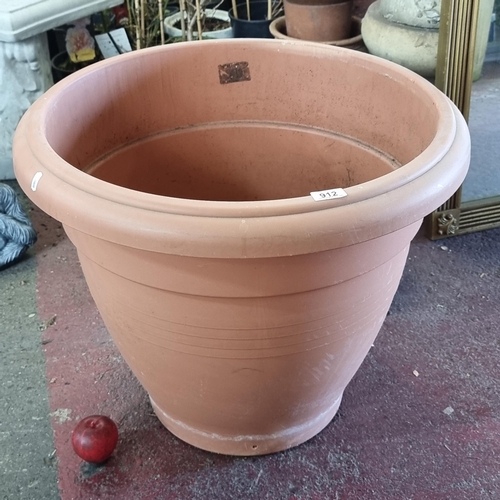 912 - A huge outdoor plastic planter in a classic shade of terracotta. H: 54cm X Diameter: 64cm