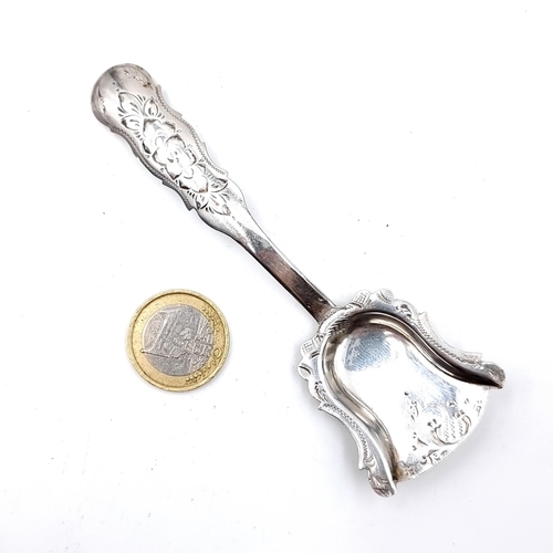 26 - A very pretty antique silver sugar spoon, set beautifully with profuse foliate detail to handle, a d... 