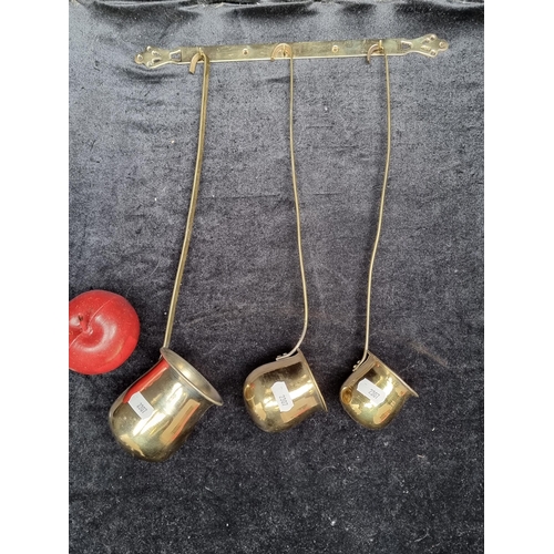 249 - Three brass spirit warmer ladles reading 'Rum', 'Whiksey' and 'Brandy'. Along with a wall key hanger... 