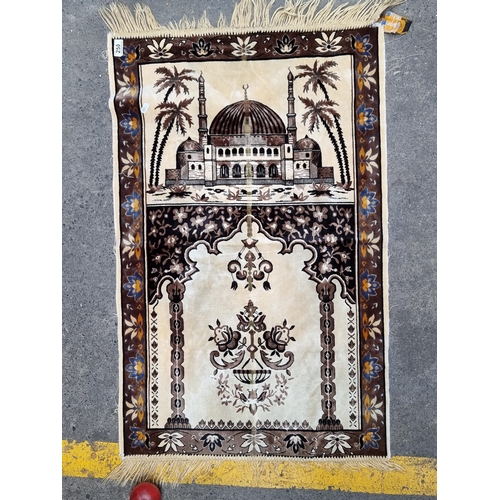 250 - A pretty and soft prayer rug featuring the Mosque and foliate designs throughout. L100cm x W63cm