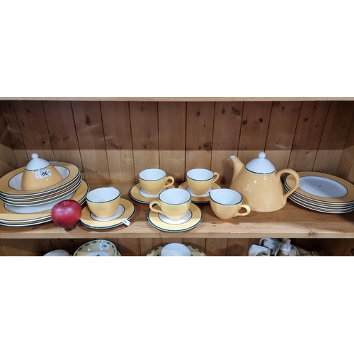 586 - Twenty one pieces of Italian made tableware designed in a warm yellow pallet with green detailing in... 