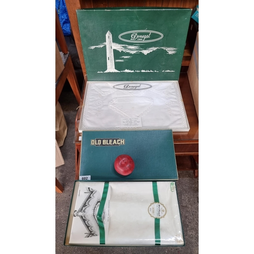 602 - Two old new stock boxes of Irish linens and table dressings including Donegal linens place mat and n... 