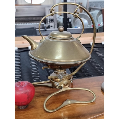 717 - An elegant Art Nouveau brass spirit kettle suspended from a sinuous art inspired frame complete with... 