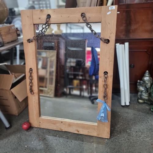 751 - A large rustic mirror held in a wooden frame with a metal chain woven throughout. Accompanied by wal... 