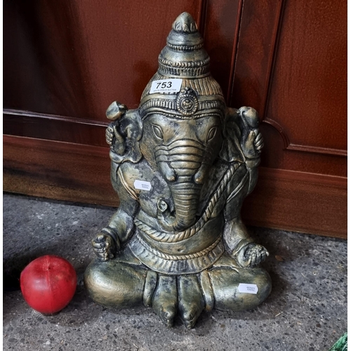 753 - A heavy garden figure in the form of an Indian deity with an elephant head.