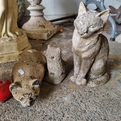 788 - Three characterful reconstituted stone garden sculptures of cats in various poses.