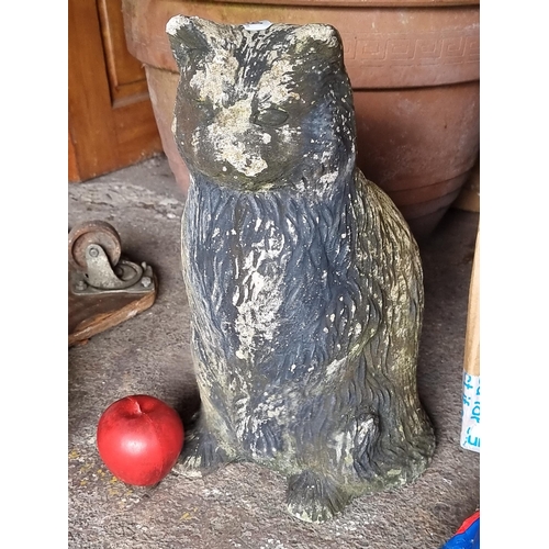 790 - A heavy reconstituted full size stone garden sculpture of a sitting black cat.