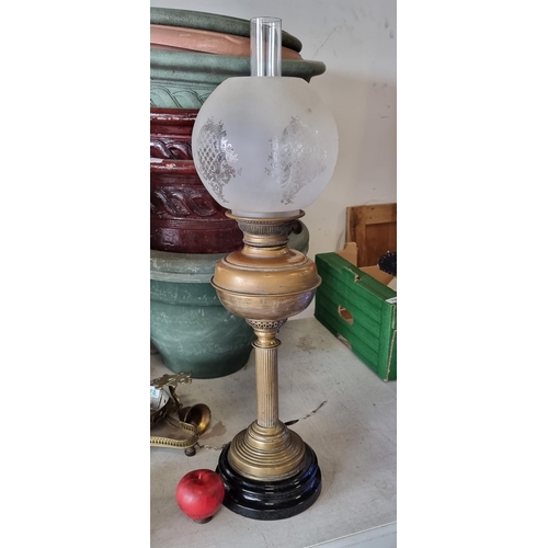 796 - A vintage brass oil lamp mounted on ceramic base with reeded column and pierced metal work. Includin... 