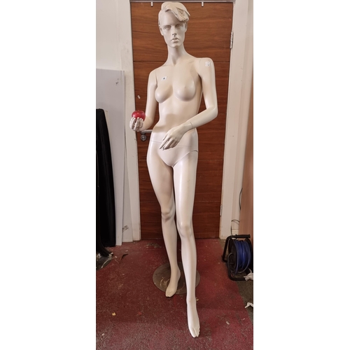 798 - A full size commercial female mannequin with movable arms, wrists, and torso. Fixed on a chrome base... 