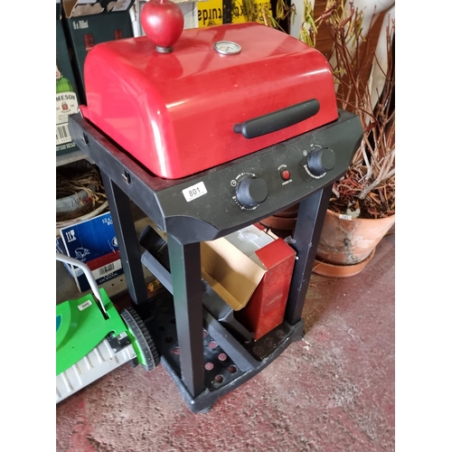 801 - A fantastic outdoor electric bbq grill with striking red lid and temperature gauge to front, griddle... 