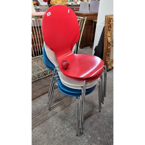 650 - A set of six dining chairs in vibrant shades of red, blue and white. Held on chrome tubular legs.