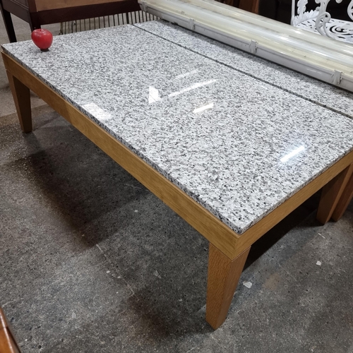 660 - Star Lot : A very stylish and contemporary coffee table with marble slab top, held on a wooden frame... 