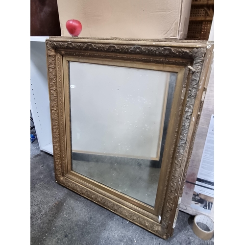 743 - An antique large and very heavy mirror held in a fabulous antique wooden frame boasting intricate fo... 