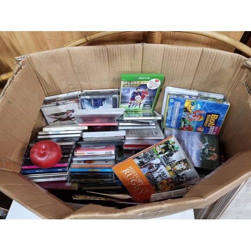 746 - A large box containing a large selection of approx. 150 DVDs and CDs including artists such as Nat K... 