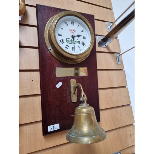 230 - A charming advertising wall clock from Carlsberg with a heavy brass bezel. Mounted on a wooden backi... 