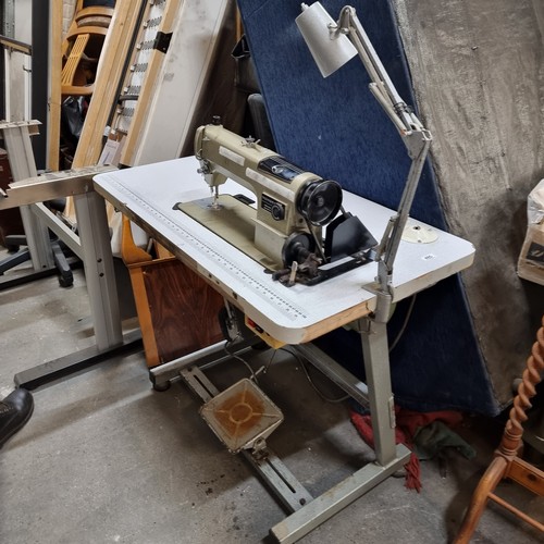 485 - An industrial grade  Toyota LS2-AD156 sewing machine set into a work table complete with foot pedal,... 