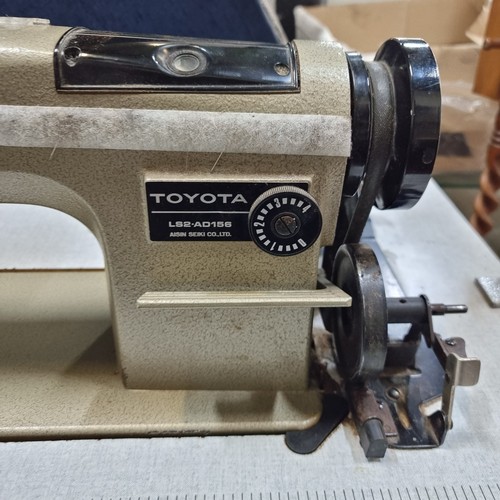 485 - An industrial grade  Toyota LS2-AD156 sewing machine set into a work table complete with foot pedal,... 