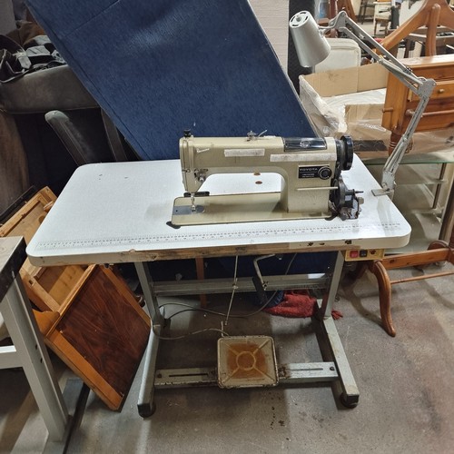 485 - An industrial grade  Toyota LS2-AD156 sewing machine set into a work table complete with foot pedal,... 