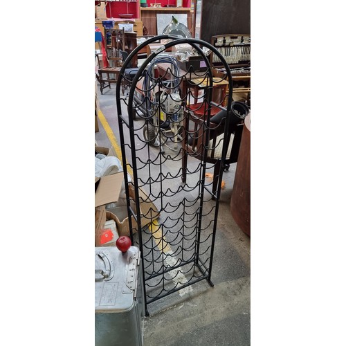 500 - A cast metal wine rack capable of holding 52 bottles. Free standing in a matte black finish. H 144