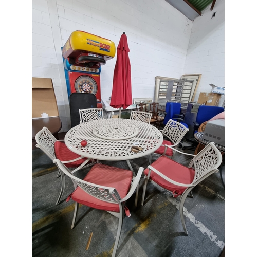 676 - Star Lot : A very large outdoor cast metal dining suite consisting of six chairs, parasol and a roun... 