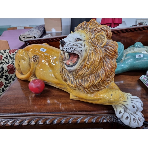 678 - A very large, vintage heavy and very characterful glazed sculpture of a roaring lion in a reclined p... 