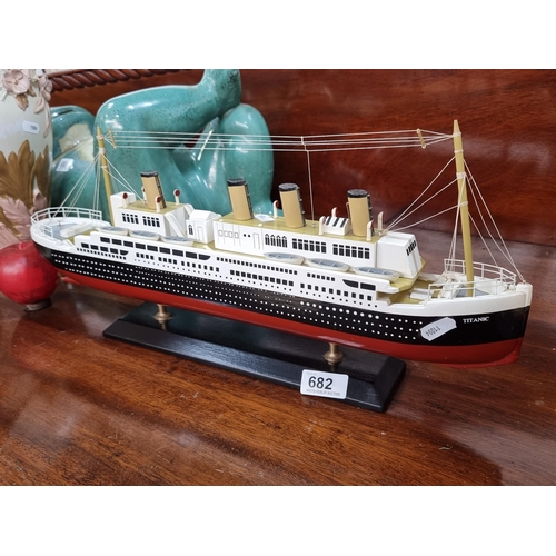 682 - A wooden model of the Titanic, mounted on a wooden base reading 