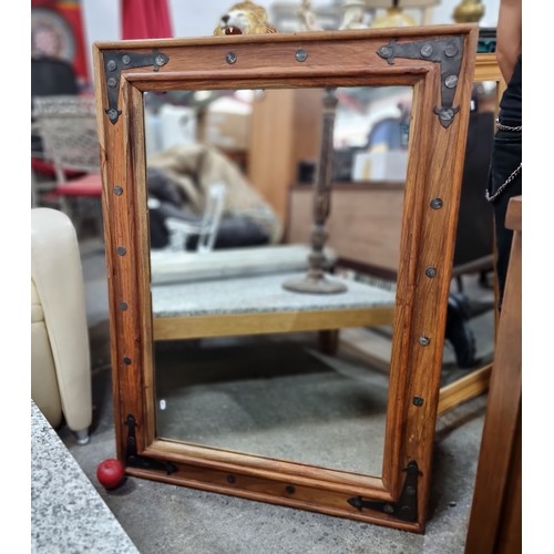 697 - A very heavy wooden frame over-mantle mirror. A large handsome example with cast metal detailing and... 