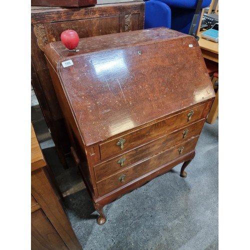 705 - A vintage bureau desk. A handsome piece with brass drop handles and three drawers on Queen Anne legs... 