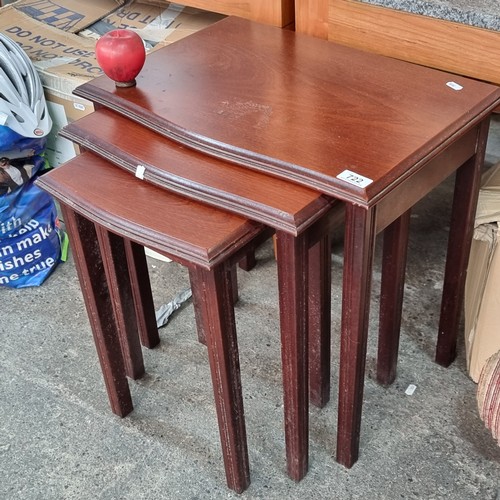 722 - A set of three vintage nesting tables with a subtle serpentine front.