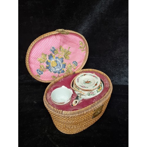 153 - A beautiful vintage Japanese tea service set comprising of a teapot and two cups boasting a floral d... 