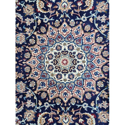 674 - Star Lot : A very large Persian handmade, hand knotted rug in shades of beige, cream, navy and green... 